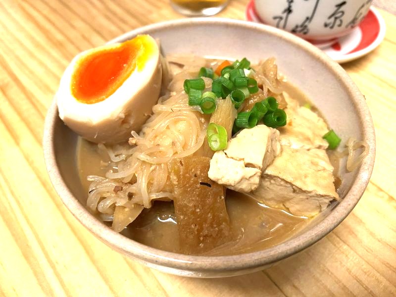 The restaurant's signature dish, "Komusubi Miso Chanko," absolutely requires a soft-boiled egg