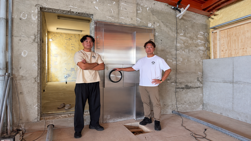 Project officials standing in front of the vault